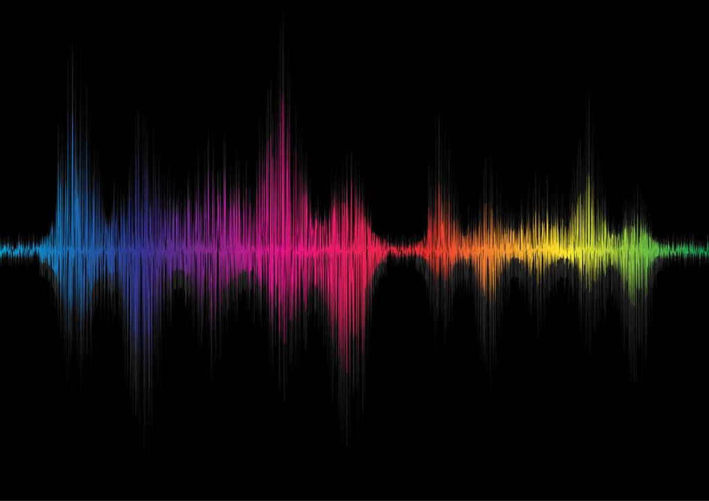 A digital soundwave with sharp peaks, rendered in a gradient of colors from blue to purple, pink, orange, yellow, and green on a black background—capturing the vibrant style of Sandy Alexander.