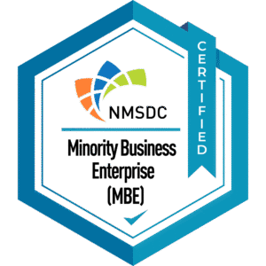 A hexagonal badge with NMSDC Minority Business Enterprise (MBE) Certified text and colorful geometric shapes above, featuring a blue ribbon on the right that says CERTIFIED..